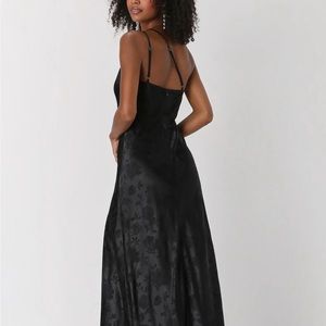 Long black dress with floral print. High slit in leg.